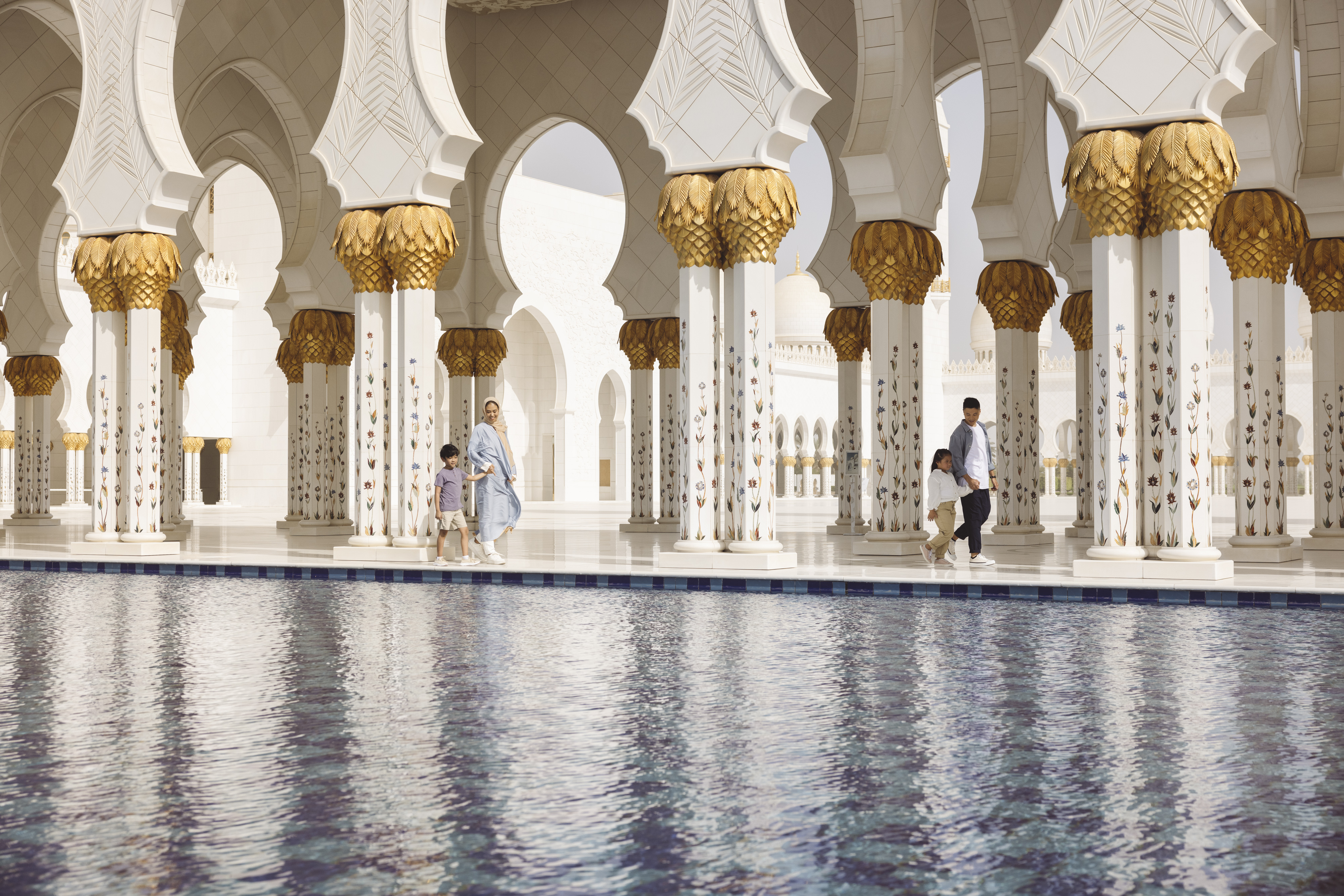 Family of 4 walking in the Sheikh Zayed Grand Mosque in Abu Dhabi 