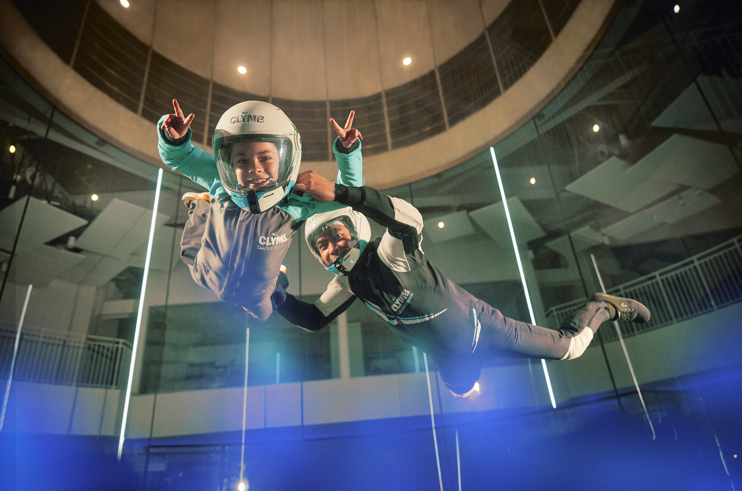 Girl and guide flying in the wind tunnel at Clymb